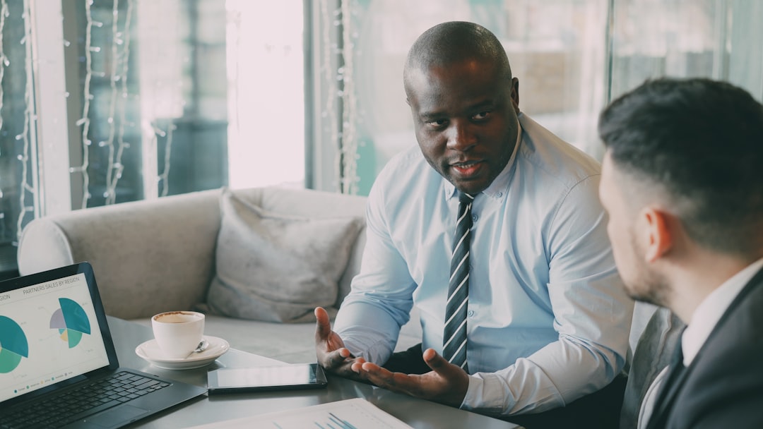 Two businessmen discussing charts in a cafe.