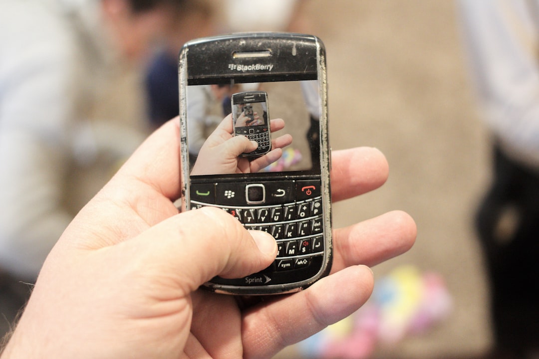 a person holding a cell phone in their hand