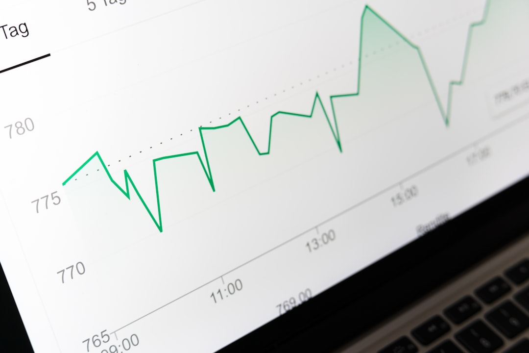 stock market chart displayed on laptop screen