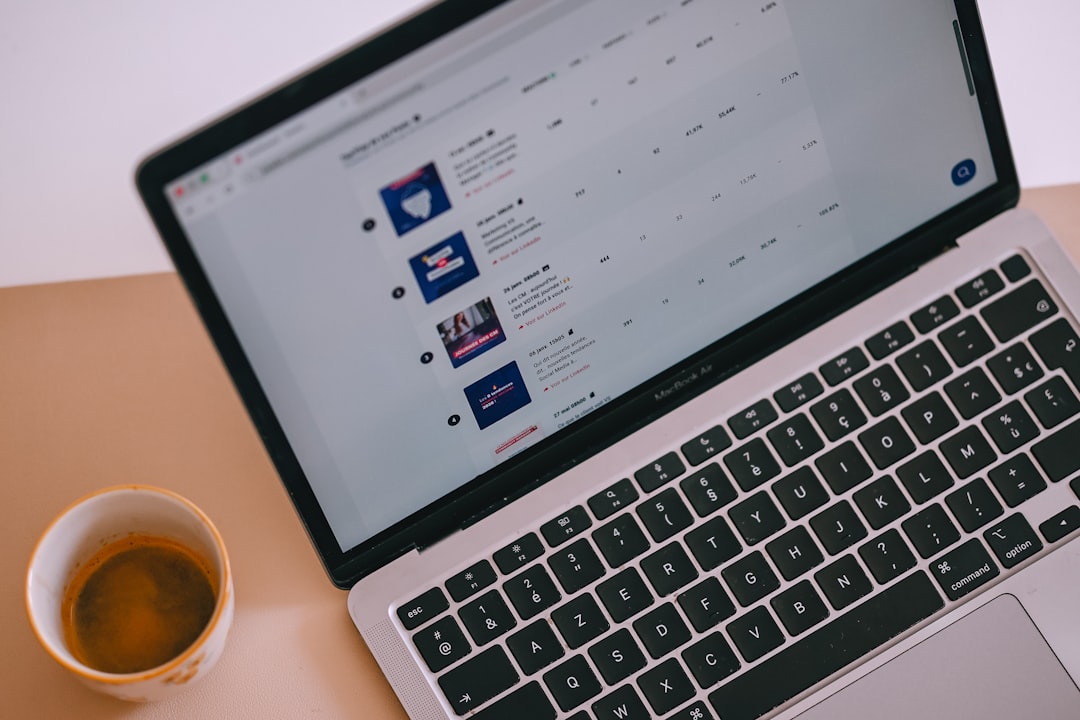 Laptop with content on screen and a cup of coffee.
